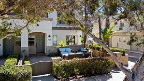 A residential property with a patio area, outdoor seating, and a well-maintained garden. - Surfer`s Paradise! Walk to Beach, Parking (San Diego)