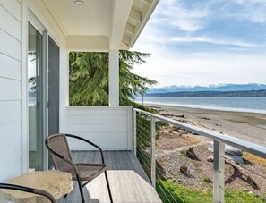Ein Balkon mit Blick auf Strand und Berge.