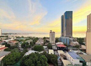 A cityscape with high-rise buildings, a marina, and a mix of residential and commercial structures. - Carnivale Inn Staycations (Manila)