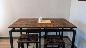A rectangular wooden table with a tray and salt shakers on top. - The Green House, RiNo - Luxury Queen Bed, Pullout Couch & Full Kitchenette (Denver)