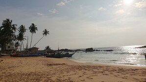 A sandy beach with boats and palm trees. - DADY`S Place `63`- Sunset Villa - 1 Floor - Beach in 2 Min (Hikkaduwa)