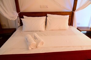 A neatly made bed with white linens and two rolled towels placed on it. - DADY`S Place `63`- Sunset Villa - 1 Floor - Beach in 2 Min (Hikkaduwa)