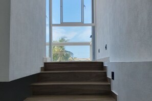 A staircase leading to a balcony with a view of palm trees and a clear sky. - DADY`S Place `63`- Sunset Villa - 1 Floor - Beach in 2 Min (Hikkaduwa)
