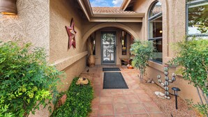 A building entrance with a tiled roof, a door with a glass panel, and a star-shaped decoration on the wall. - On the Rocks - Beautiful 3 BR / 2 bath home nestled in the heart of West Sedona (Sedona)