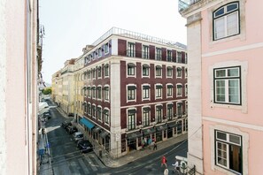 A multi-story building with a ground-floor commercial space, large windows, and a pedestrian street. - Awarded 3 bedrooms upscale flat@Chiado/Bairro Alto (Lisboa)