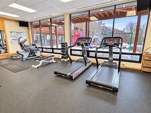 A gym with treadmills, a stationary bike, and weight machines.