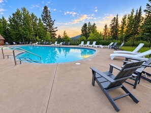 A swimming pool with lounge chairs and a concrete deck. - Slope-Side Pet-Friendly Studio | In-Unit Jet Tub (Lutsen)