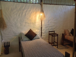 A room with a bed, a chair, a hanging lamp, and a wall-mounted light fixture. - Refúgio Do Sagrado Morere  (Morere Boipeba)