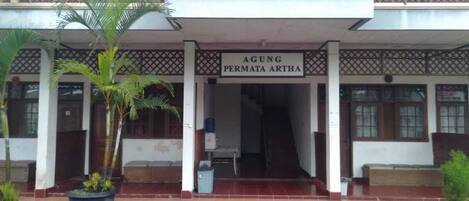 A building with a sign reading "AGUNG PERMATA ARTHA".