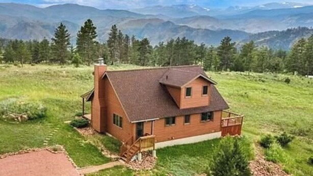 A single-story wooden house with a sloped roof, a front porch, and a small deck. - Panoramic Views! 'The Cozy Fox Cabin' in Livermore (Livermore)