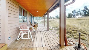 A wooden deck with outdoor seating and a covered area. - Panoramic Views! 'The Cozy Fox Cabin' in Livermore (Livermore)