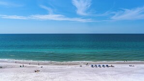 Una playa con cielo despejado y mar tranquilo.