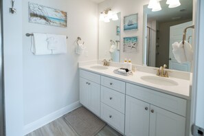A bathroom with two sinks, a large mirror, and artwork on the walls. - Tranquil Coastal Escape - Just Steps to the Beach - Bikes included (Port St. Joe)