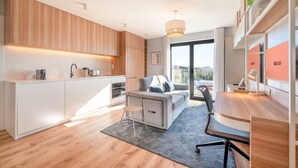 A modern apartment with a kitchen, living area, and a balcony with a city view. - GuestReady - Maleo Living Apartments - 10C1 (Lisbon)