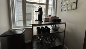 A kitchen with a coffee maker, mugs, and a metal shelf. - The Battlefield Getaway (Monroe)
