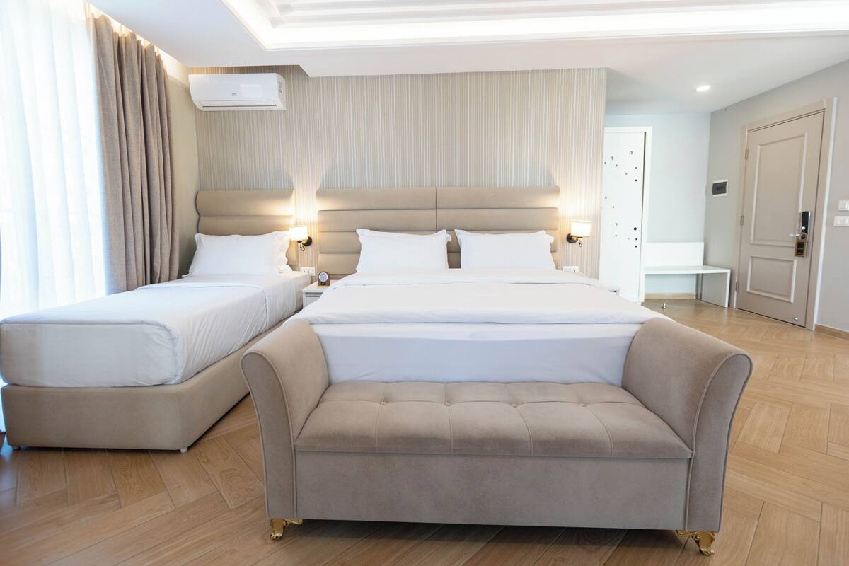 Triple Room, Balcony, Pool View | Desk, WiFi (free), bed sheets