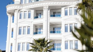 A multi-story building with balconies and large windows. - FAFA Aqua Blue Hotel (Golem)
