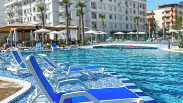 Seasonal outdoor pool, open 9:00 AM to 6:00 PM, pool umbrellas