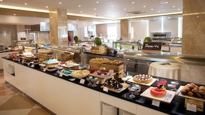 A buffet with various desserts and a sign indicating a section for 'Desserts'. - FAFA Aqua Blue Hotel (Golem)