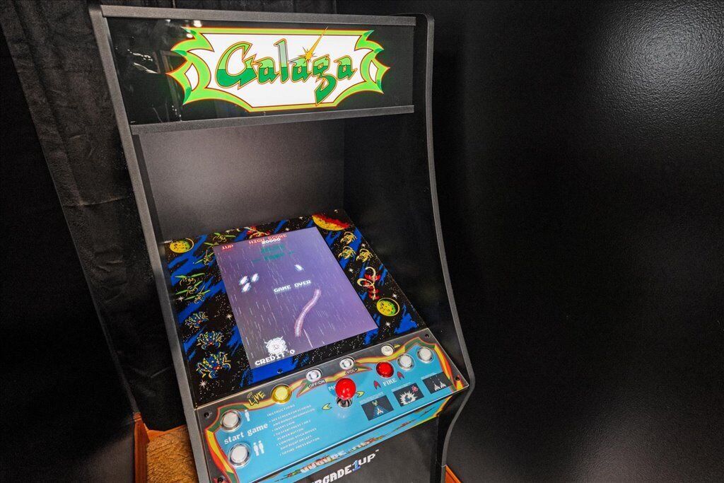 Een ruimtevaart-thema automaat met een ‘GAME OVER’ scherm, gelabeld ‘Galaga’, en een ‘START’ knop.