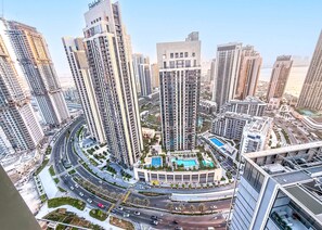 A high-rise residential building complex with multiple towers, a central landscaped area with a pool, and a surrounding road network. - Stayshort - Modern Apartment Sleeps Two Dubai Creek Views (Dubai)
