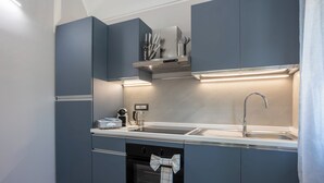 A modern kitchen with grey cabinets, a stainless steel sink, and a built-in oven. - Entire floor: 8 beds (Vercelli)