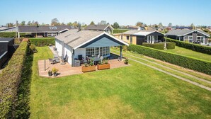 A residential area with modern houses, a well-maintained lawn, and a clear sky. - 4 Star Holiday Home in Hejls (Hejls)