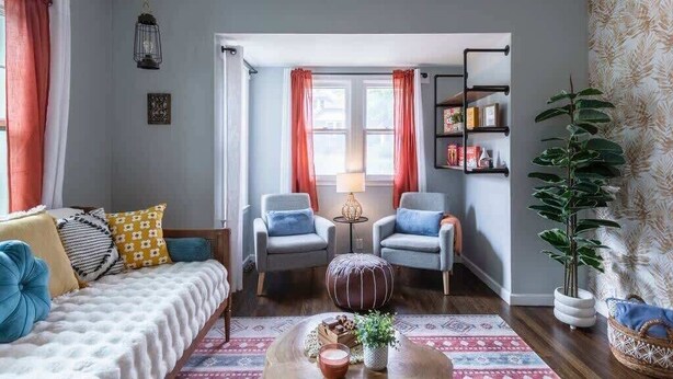 A cozy living room with a sofa, two armchairs, a coffee table, and a bookshelf. - Modern Midtown Getaway! Central location for 12! (Omaha)