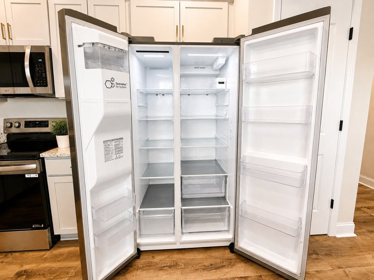 A modern kitchen with a built-in refrigerator, a microwave, and a stove.