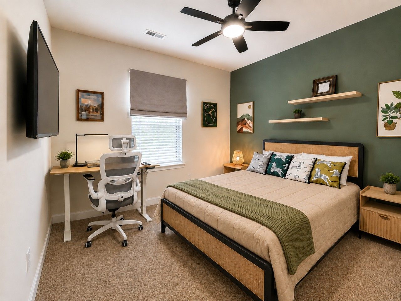 A bedroom with a bed, desk, chair, and a ceiling fan.