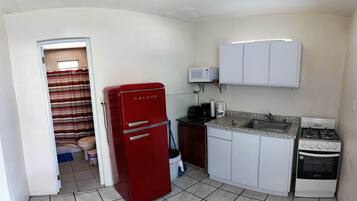Full Kitchen with a microwave, coffee pot, toaster and cooking sets and eating sets