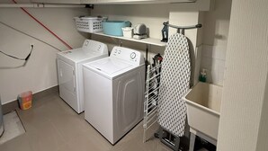 A laundry room with two washing machines, a drying rack, and a shelf with laundry supplies. - Spacious 2BR Basement • Full Kitchen • Vaughan (Vaughan)