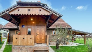 A wooden house with a sloped roof, a wooden front door, and a small porch with steps leading up to it. - Stunning home in Velika Jamnicka with sauna (Velika Jamnicka)