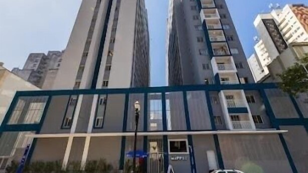 Un edificio de gran altura con varios pisos, que presenta un diseño arquitectónico moderno con un llamativo esquema de color azul y blanco.