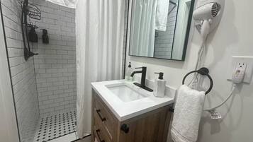 Shower, hair dryer, towels, soap