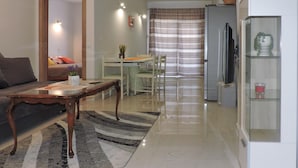 A compact living space with a dining area, a kitchenette, and a seating area with a sofa and a table. - Nice apartment in Peroj with swimming pool (Peroj)
