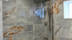 A modern bathroom with a glass-enclosed shower, a white bathtub, and a toilet. - Luxe Haven Room, with a Private Bathroom with a Separate Entrance from the House (Waynesboro)