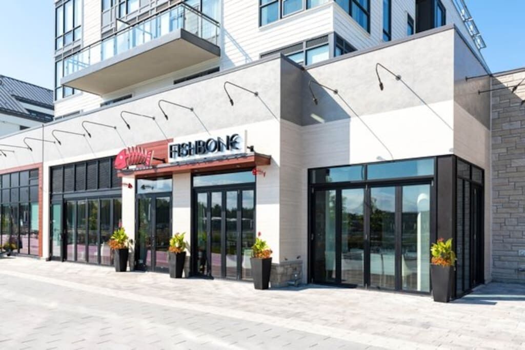 A modern building with a storefront labeled "FASHION BONK."