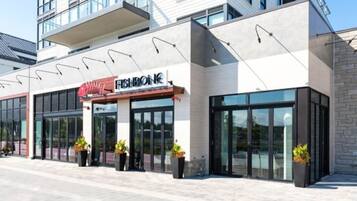 A modern building with a storefront labeled "FASHION BONK."