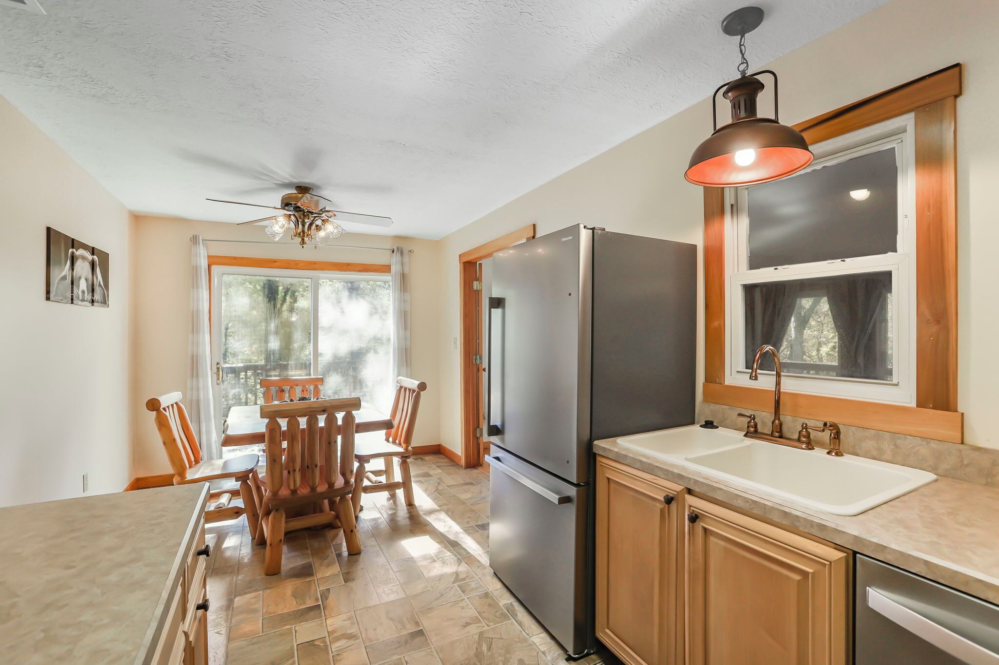 A modern kitchen with a large island, stainless steel appliances, and a farmhouse sink.
