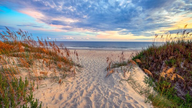 A beach with sand dunes and grass. - New & Modern Home in Southport • Family & Pet Friendly (Southport)