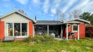 A two-story house with a covered porch, a garage, and a small shed. - 2 bedroom beautiful home in Orø (Orø)