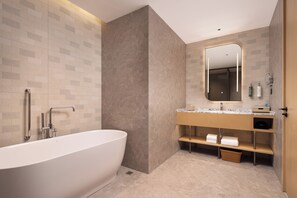 Deluxe Suite, 1 King Bed | Bathroom | Shower, rainfall showerhead, designer toiletries, hair dryer