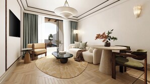 A modern living room with a flat-screen TV, a round coffee table, a sofa, a chair, a small table with a vase, and a lamp. - Conrad Corfu (Corfu)