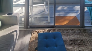 A room with a large sliding glass door leading to an outdoor deck. - Oceanfront Condo*Walkout Patio Beach Access*Steps to the Sea* (North Myrtle Beach)
