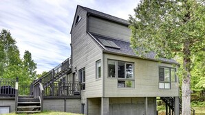 A two-story house with a modern design, featuring a large garage and a staircase leading to the upper floor.