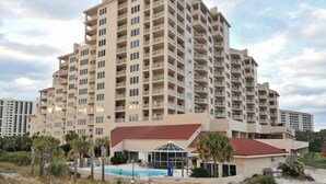 A high-rise hotel with multiple balconies, a swimming pool, and a beach view. - 2BR Gulf-front condo w/ private balconies (Miramar Beach)