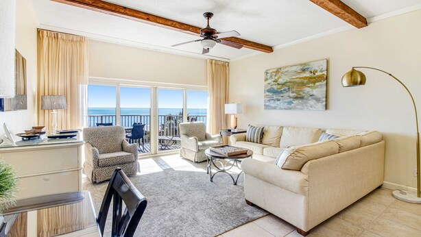 A spacious living room with a sofa, armchairs, a coffee table, and a ceiling fan. - 2BR Gulf-front condo w/ private balconies (Miramar Beach)