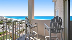 A balcony with two Adirondack chairs overlooking a beach and ocean. - Exclusive 3BR Beachfront with Gulf Views (Miramar Beach)