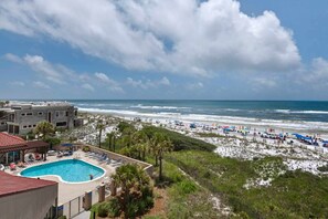 A beachfront hotel with a swimming pool, beach access, and a view of the ocean. - Beachfront Gulf Views | Pool Access (Miramar Beach)
